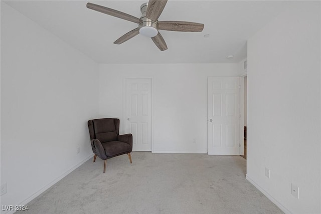 unfurnished room with ceiling fan and light carpet