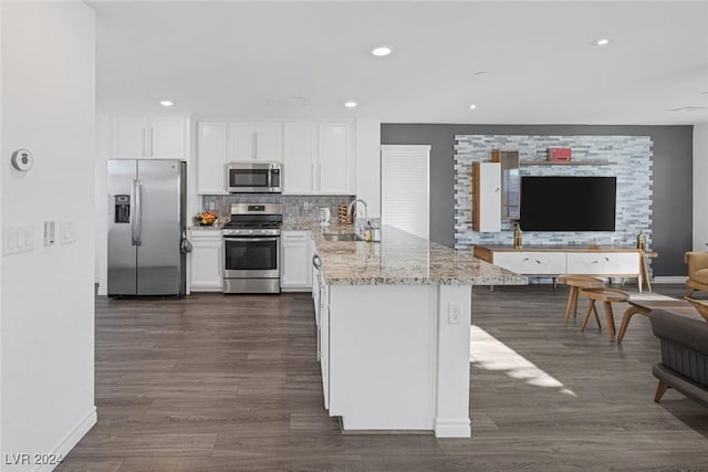 kitchen featuring white cabinets, kitchen peninsula, sink, and appliances with stainless steel finishes