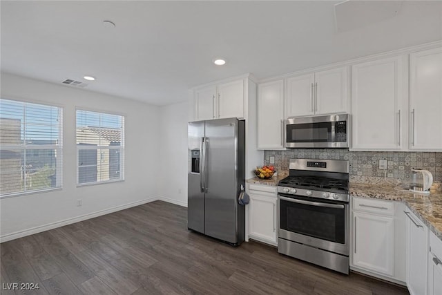 kitchen featuring dark hardwood / wood-style flooring, white cabinetry, light stone counters, and appliances with stainless steel finishes