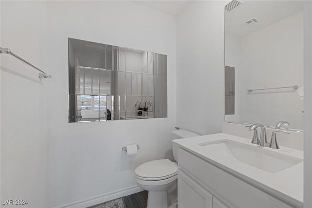 bathroom featuring vanity and toilet