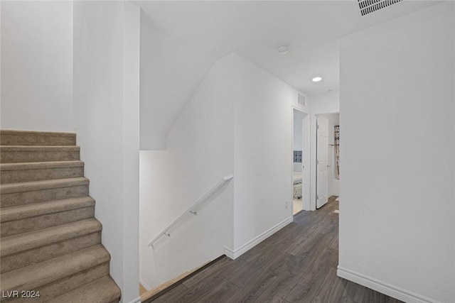 corridor with dark hardwood / wood-style flooring