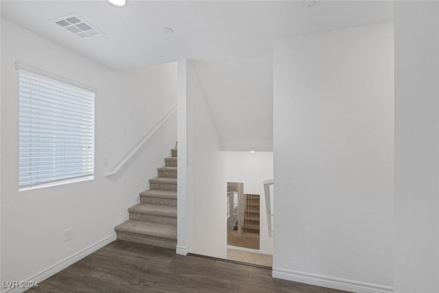 staircase with hardwood / wood-style floors