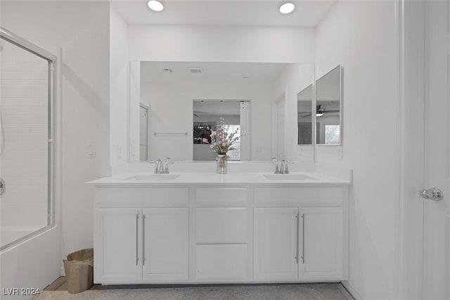 bathroom with ceiling fan, vanity, and bath / shower combo with glass door