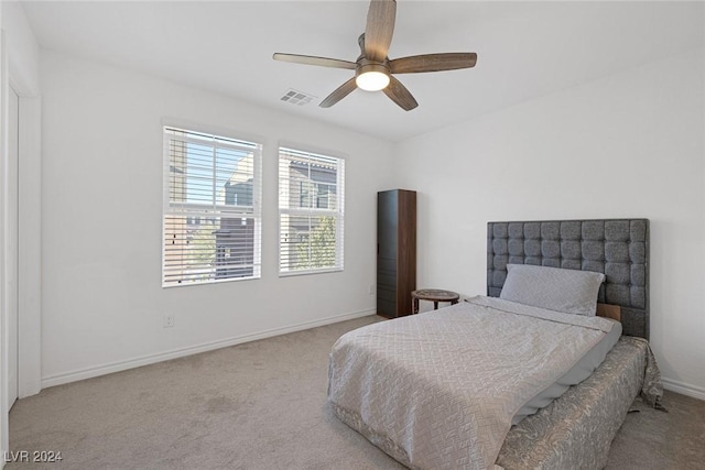 bedroom featuring light colored carpet and ceiling fan