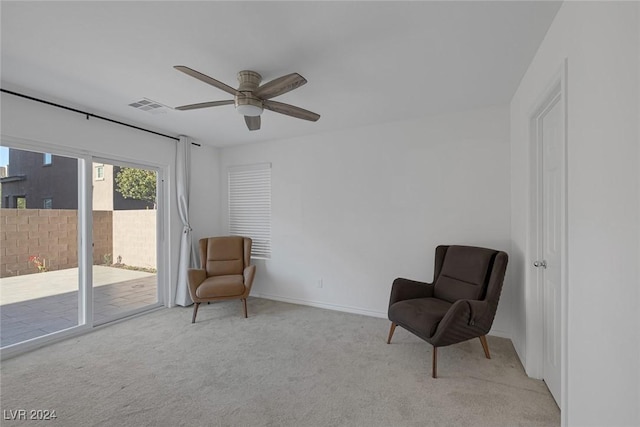 sitting room featuring light colored carpet and ceiling fan