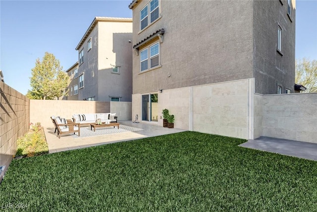 rear view of property with outdoor lounge area, a patio, and a lawn