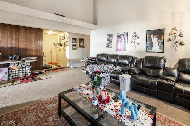 living room featuring carpet flooring and wooden walls