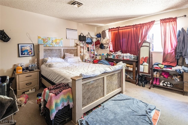 carpeted bedroom with a textured ceiling