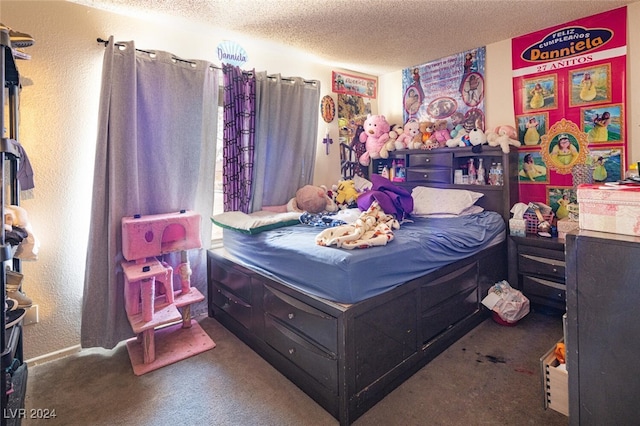 bedroom featuring carpet flooring and a textured ceiling