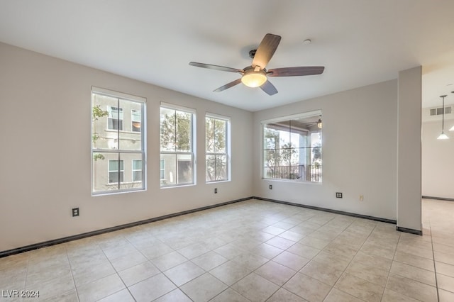 unfurnished room with ceiling fan and light tile patterned flooring