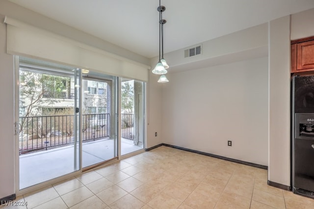 unfurnished dining area with light tile patterned floors