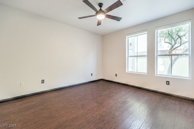 empty room featuring dark hardwood / wood-style flooring and ceiling fan