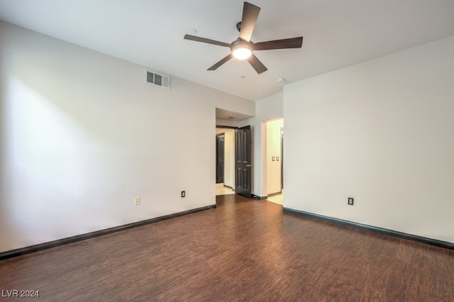 unfurnished room with dark hardwood / wood-style floors and ceiling fan