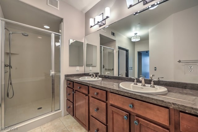 bathroom with tile patterned floors, vanity, and walk in shower