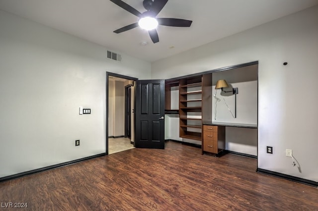 unfurnished bedroom featuring a closet, ceiling fan, and dark hardwood / wood-style flooring