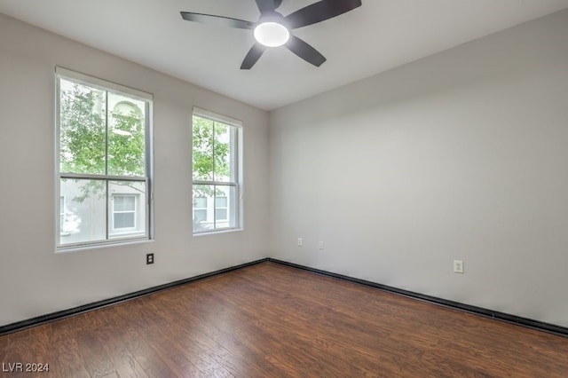 unfurnished room with ceiling fan and dark wood-type flooring