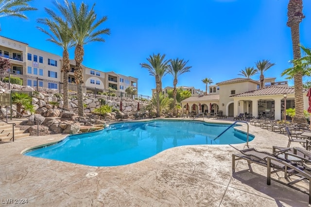 view of swimming pool with a patio