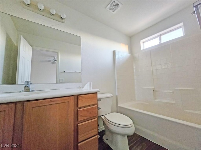 full bathroom with bathtub / shower combination, vanity, ceiling fan, wood-type flooring, and toilet