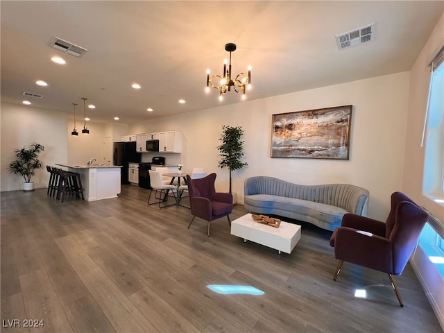 living room with a chandelier and dark hardwood / wood-style flooring