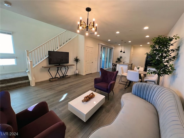 living room with a notable chandelier and dark wood-type flooring