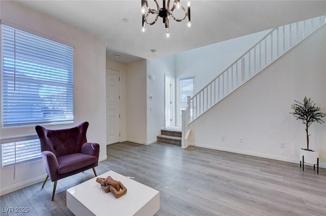 living area featuring a chandelier and light wood-type flooring