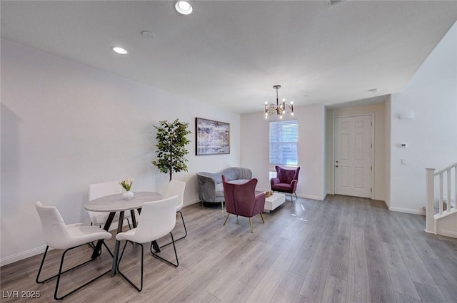 dining room with an inviting chandelier and light wood-type flooring