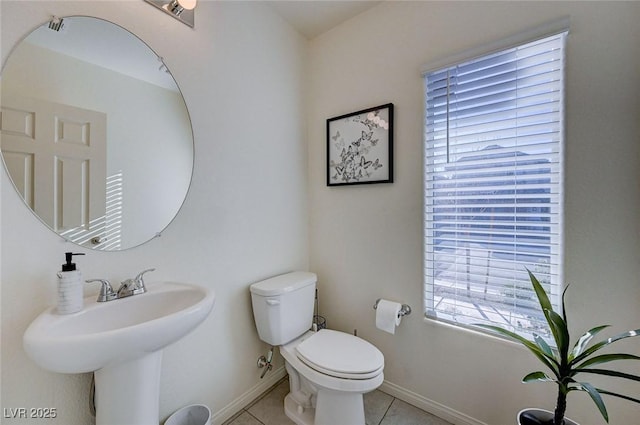 bathroom featuring tile patterned floors, toilet, and sink