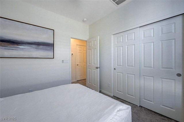 unfurnished bedroom featuring dark carpet and a closet