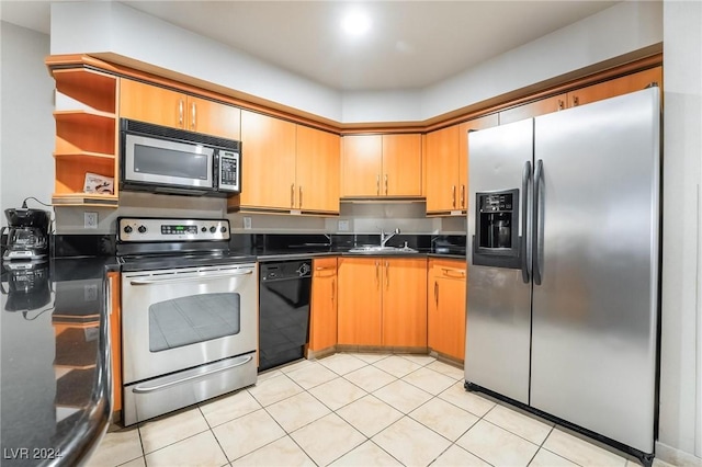 kitchen with light tile patterned floors, sink, and appliances with stainless steel finishes