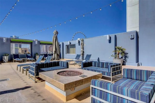 view of patio featuring an outdoor living space with a fire pit