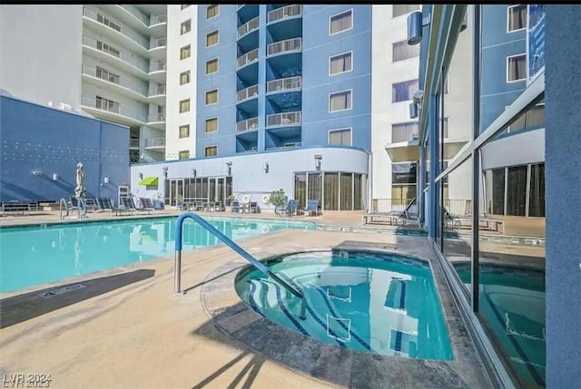 view of pool featuring a patio area and a community hot tub