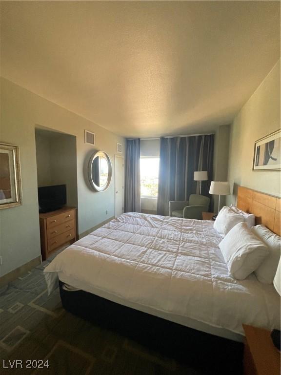 bedroom featuring dark colored carpet