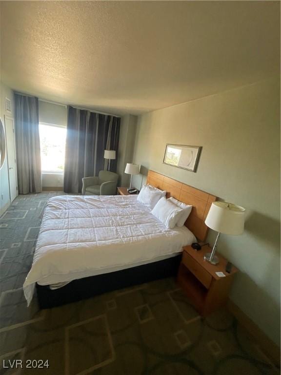 211 E Flamingo Rd Unit 614, Las Vegas, NV 89169 - carpeted bedroom with a textured ceiling