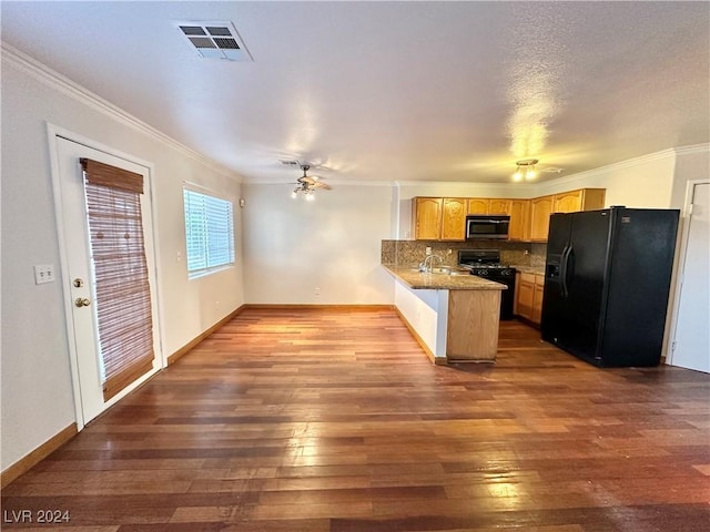 kitchen with dark wood-style flooring, visible vents, backsplash, a peninsula, and black appliances