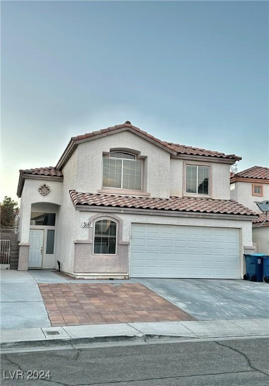 mediterranean / spanish home featuring a garage