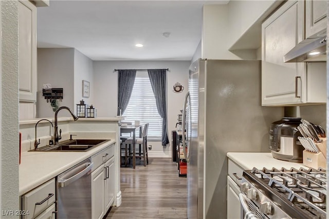 kitchen featuring sink, white cabinets, hardwood / wood-style floors, and appliances with stainless steel finishes