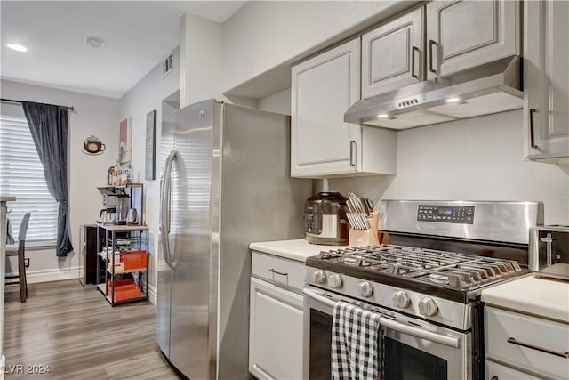 kitchen featuring white cabinets, appliances with stainless steel finishes, and light hardwood / wood-style floors