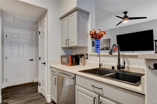 kitchen with ceiling fan, sink, dark hardwood / wood-style flooring, stainless steel dishwasher, and white cabinets