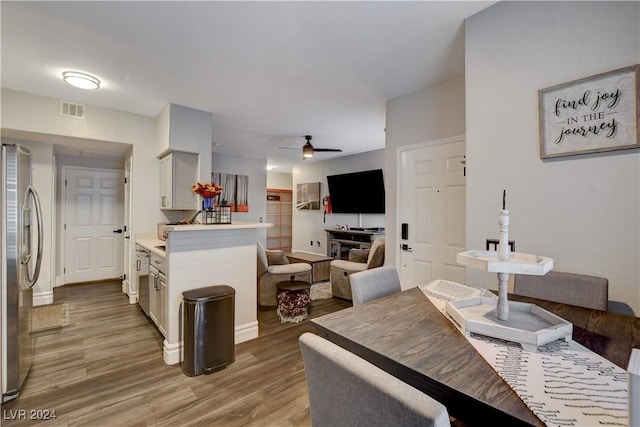 dining room with ceiling fan and wood-type flooring