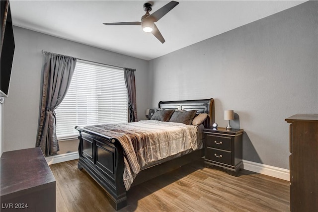 bedroom with ceiling fan and dark wood-type flooring