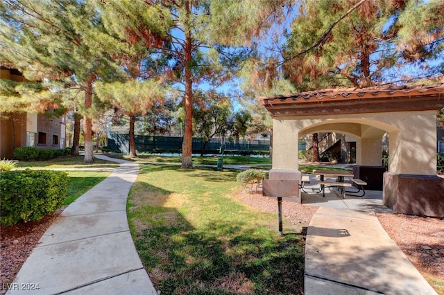 view of home's community featuring a yard and a patio