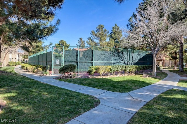 surrounding community with a lawn and tennis court