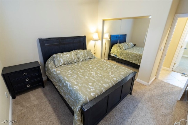 bedroom with a closet, carpet, and baseboards