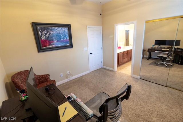 home office with light colored carpet and baseboards