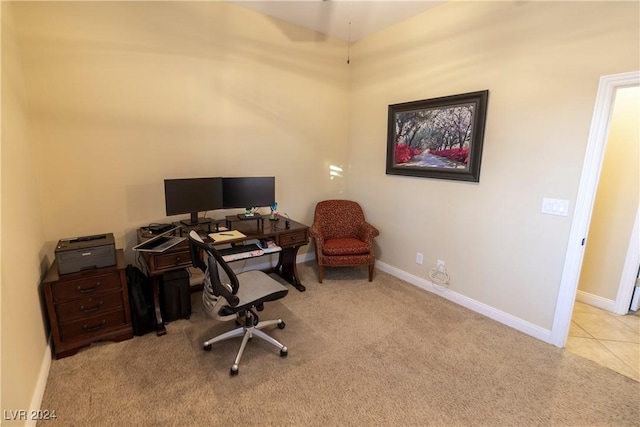 carpeted home office with tile patterned floors and baseboards