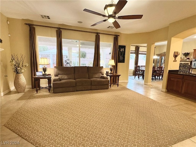 living room with ceiling fan and light tile patterned flooring