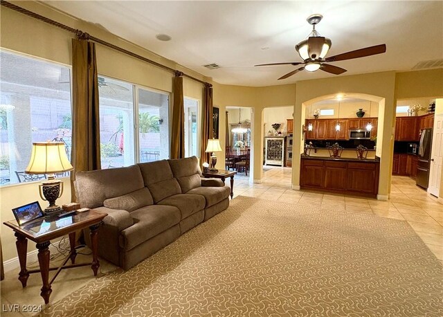 tiled living room featuring ceiling fan