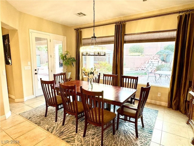 dining room with baseboards, visible vents, a notable chandelier, and light tile patterned flooring