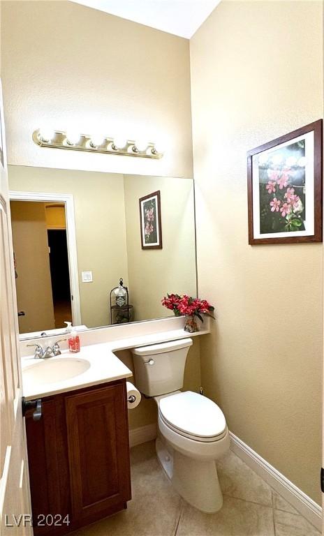 bathroom featuring tile patterned floors, vanity, and toilet