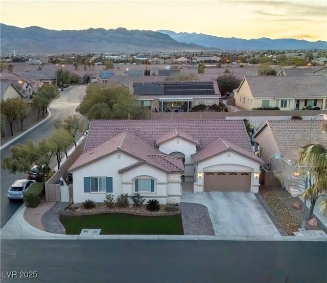 aerial view at dusk with a residential view and a mountain view